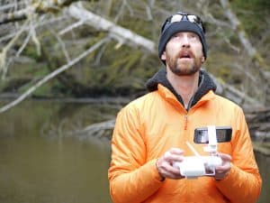 Man Operating Drone by Lake