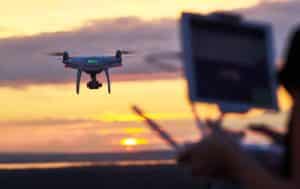 Operator Flying Drone At Sunset