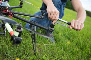 Man Adjusting Rotor on Drone