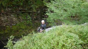 Woman Operating Drone in Forest