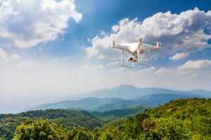 Drone Flying Above Green Mountains