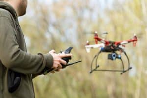 Man Flying Drone in Forest