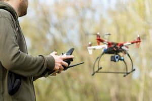 Man Operating Drone in Forest