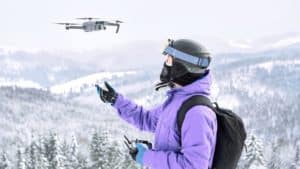 Man flying drone in winter