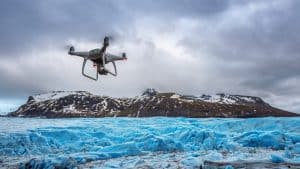 Drone Flying Above Iceberg