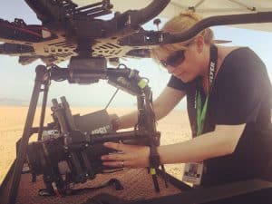 Woman Adjusting Camera and Drone