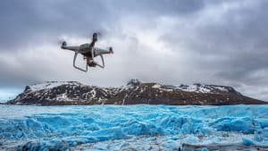 Drone Flying Above Iceberg