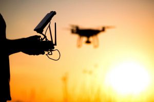 Man Operating Drone In Sunset