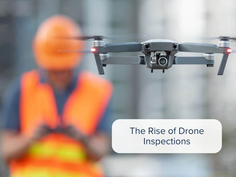 A worker on a construction site piloting a drone for an inspection.