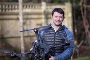 Man Holding Drone Smiling