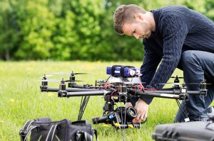Man Adjusting Drone Camera Equipment