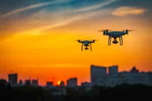 Two Drones Flying At Sunset