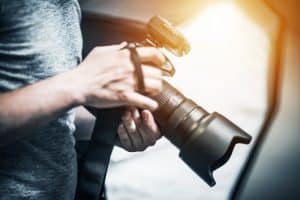 Man Holding Large Camera