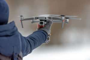 Man Holding Drone Before Flight