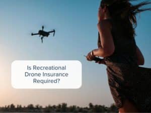 Recreational srone pilot operating her drone in a field