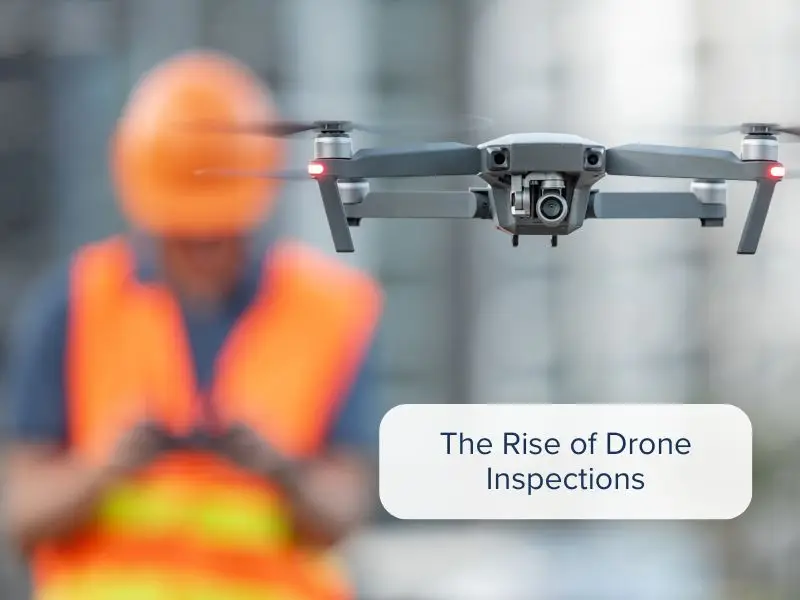 A worker on a construction site piloting a drone for an inspection.