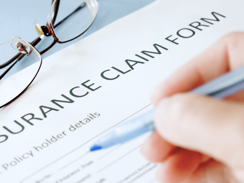 Person filling in insurance claims form - The Top 10 Reasons for Drone Insurance Claims