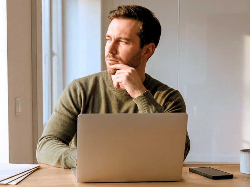 Man at a desk thinking about the value of Drone Insurance