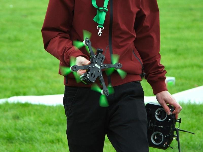 Drone pilot carrying a drone