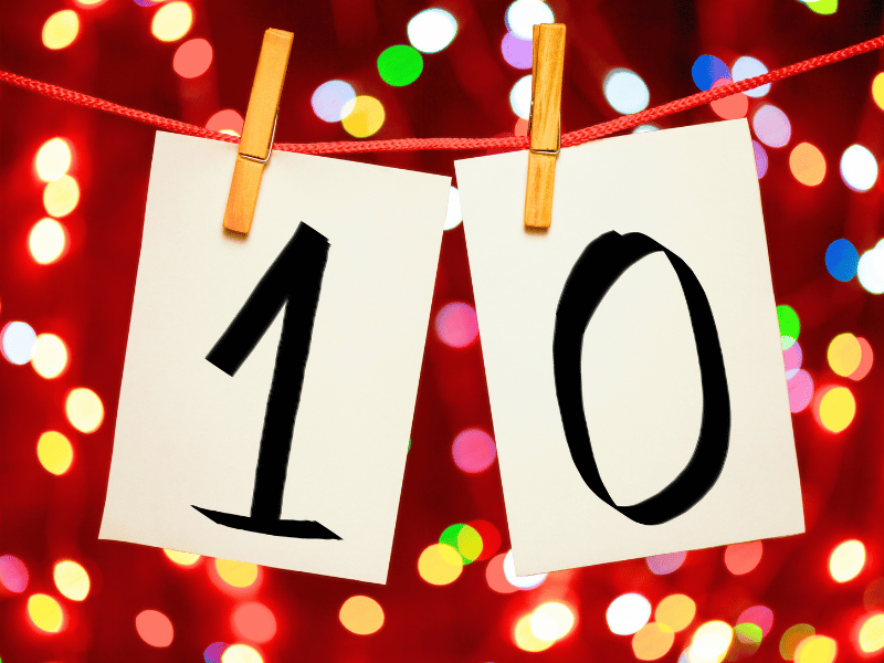10 sign pegged to cord with lights in background
