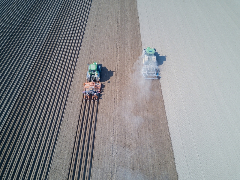 A drone aerial view of two harvesters working on a field