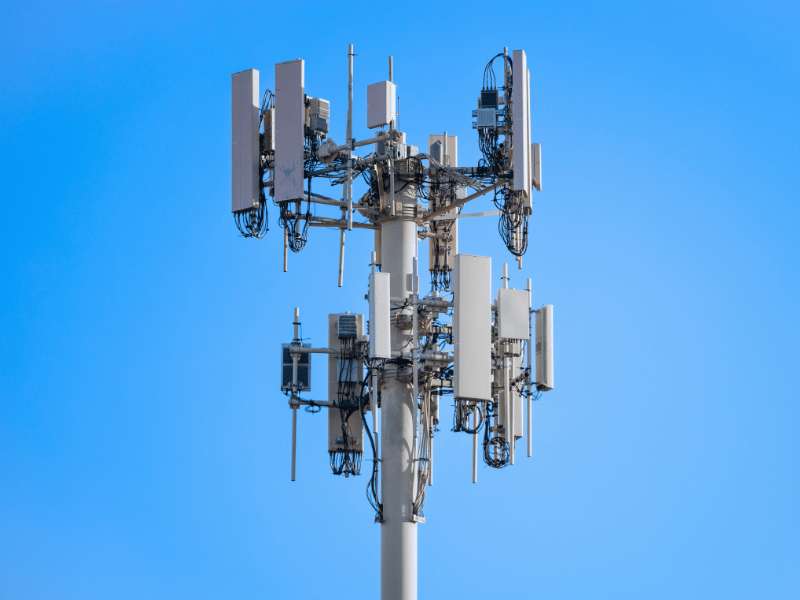 Mobile communications tower against a blue sky background